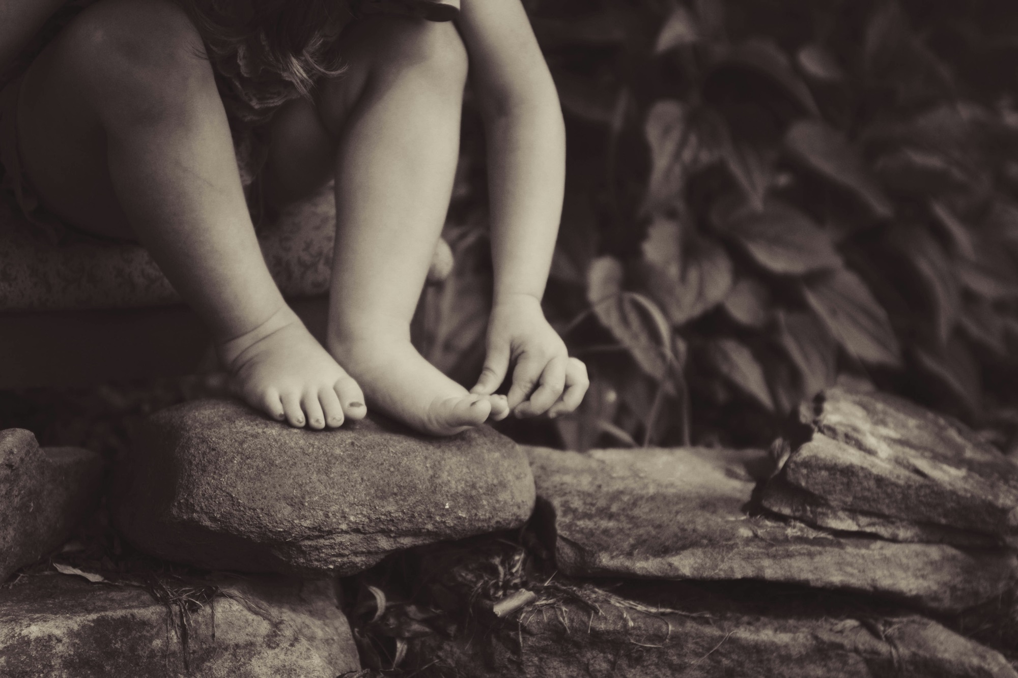 kid foot on rocks